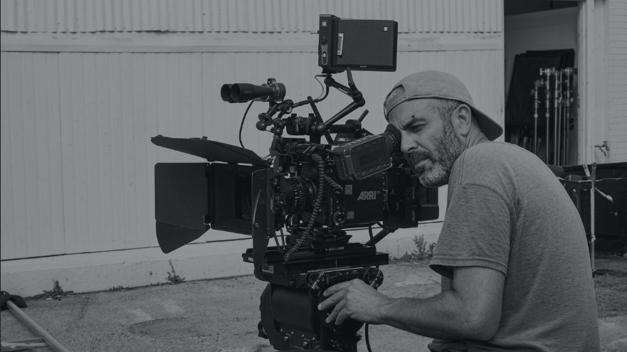 Shaheen Seth operating an ARRI camera on set, in black and white